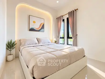 Modern bedroom with cozy bed, elegant lighting, and large window for natural light.
