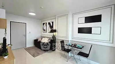 Modern living room with stylish decor and dining area in open layout apartment.