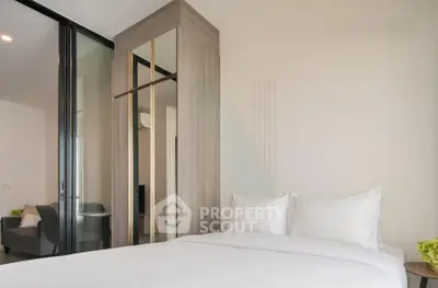 Modern bedroom with sleek design and comfortable bedding in a stylish apartment.