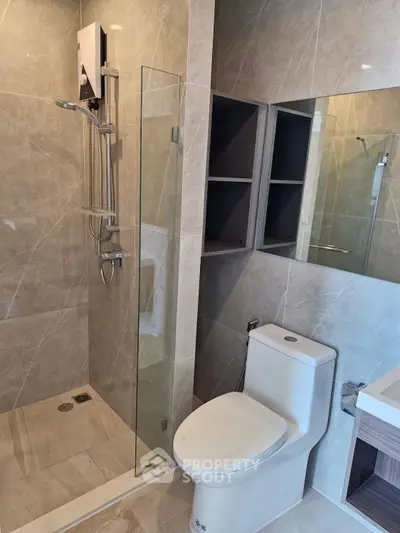Modern bathroom with sleek shower and elegant fixtures in luxury apartment.