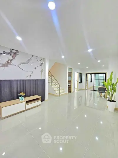 Spacious modern living room with elegant decor and glossy tile flooring