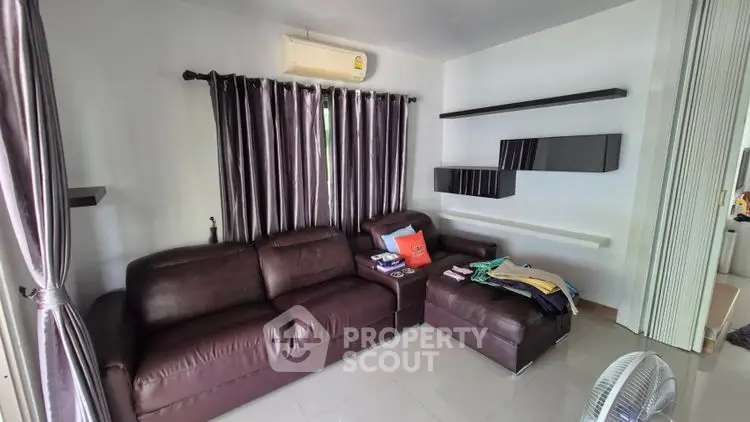 Modern living room with sleek leather sofa and stylish shelving
