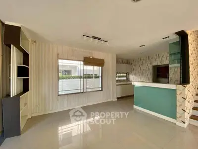 Spacious modern living room with large window and stylish interior design