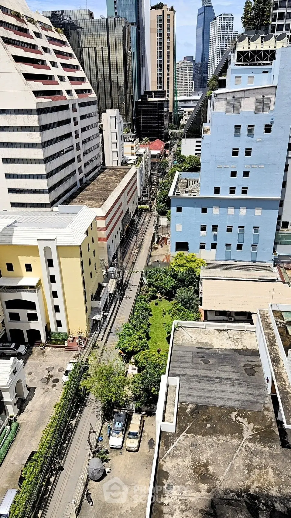Stunning urban cityscape view from high-rise building showcasing vibrant architecture and lush greenery.