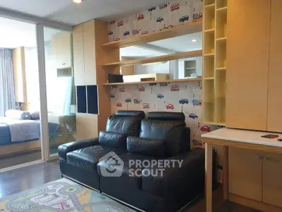 Modern living room with stylish black leather sofa and playful wallpaper