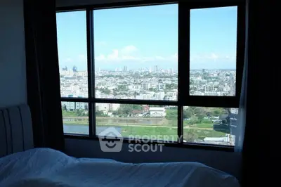 Stunning cityscape view from a modern bedroom window, perfect for urban living.