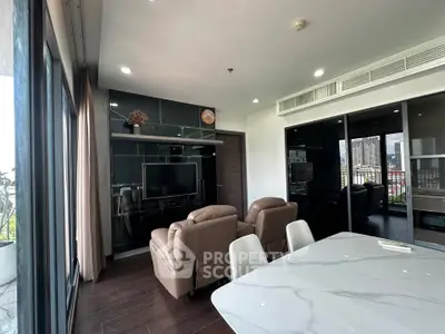 Modern living room with sleek design and city view, featuring comfortable seating and stylish decor.