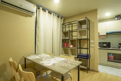 Modern dining area with stylish shelving and kitchen view