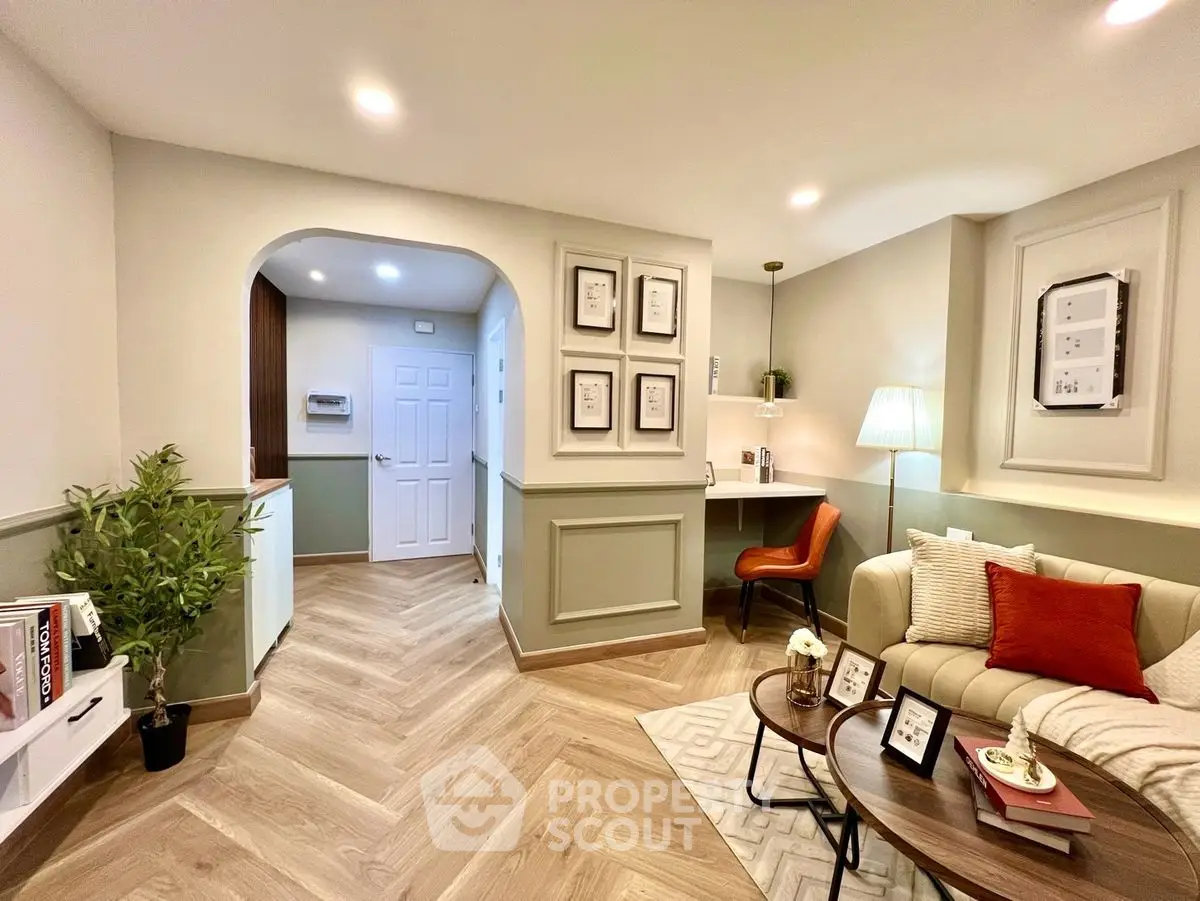 Charming living room with cozy seating and stylish decor, perfect for relaxation and entertaining.