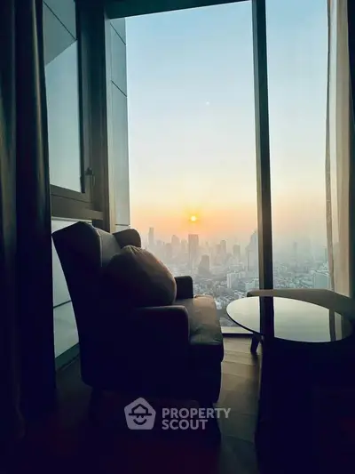 Luxurious high-rise apartment with stunning city skyline view at sunset.