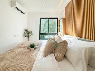 Modern bedroom with cozy bedding and stylish wooden accent wall