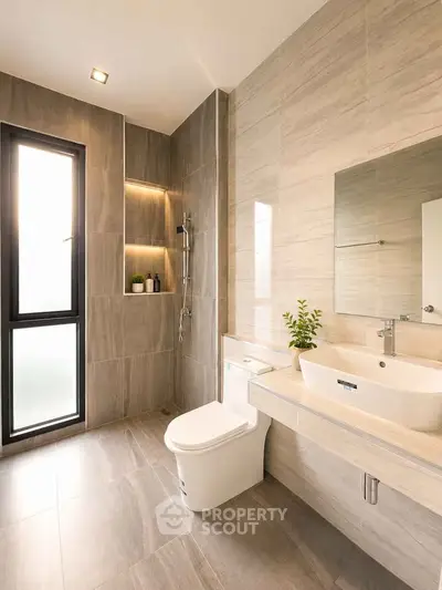 Modern bathroom with sleek design, featuring a large window, elegant fixtures, and stylish tiling.