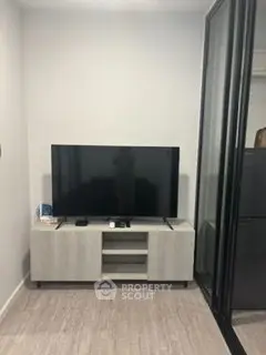 Modern living room with sleek TV stand and large flat-screen TV