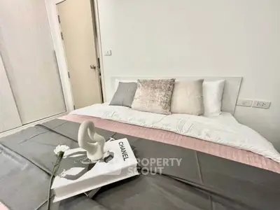 Elegant bedroom with stylish decor and cozy bedding in modern apartment.