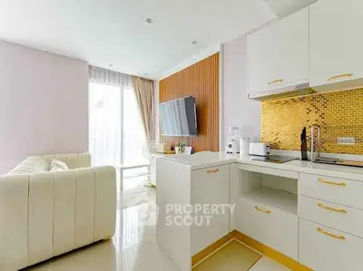 Modern open-layout kitchen with stylish living room and elegant decor