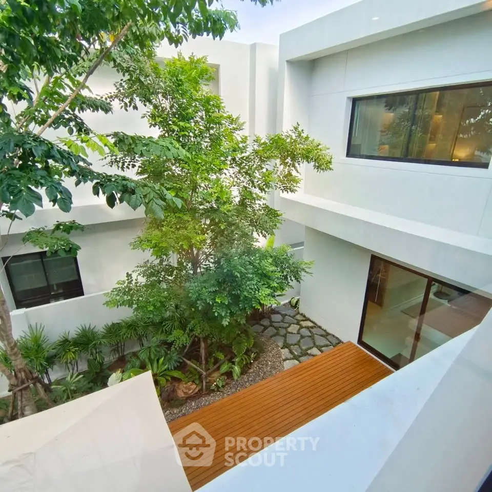Modern minimalist home with lush courtyard and large windows