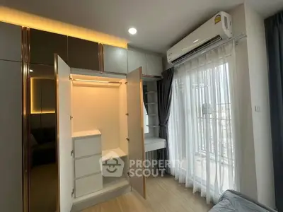 Modern bedroom with open wardrobe and balcony view, featuring sleek design and natural light.