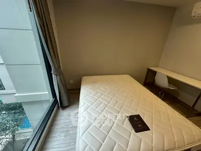 Modern bedroom with large window and minimalist furniture