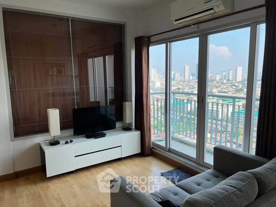 Modern living room with city view, featuring sleek furniture and large windows for natural light.