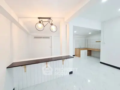 Modern minimalist kitchen with open layout and stylish lighting