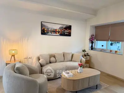 Modern living room with stylish furniture and elegant decor, featuring a cozy sofa and ambient lighting.