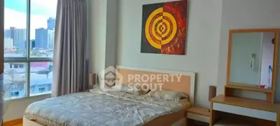 Spacious bedroom with modern decor and city view, featuring a comfortable bed and stylish artwork.