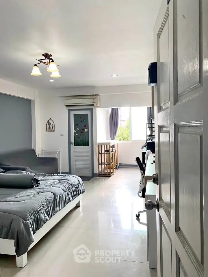 Spacious bedroom with modern decor and ample natural light