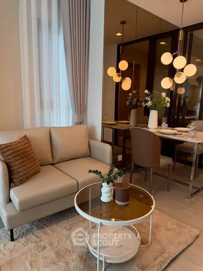 Stylish modern living room with elegant dining area and chic lighting in a cozy apartment.
