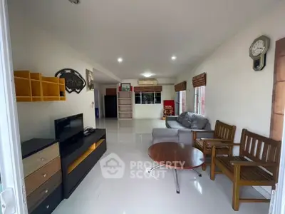 Spacious living room with modern furniture and entertainment setup, perfect for relaxation and gatherings.