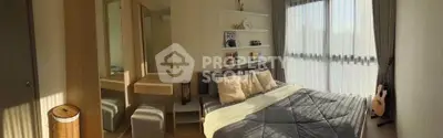 Cozy bedroom with natural light, modern decor, and a guitar by the window.