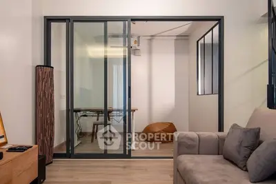 Modern living room with glass partition and cozy seating area