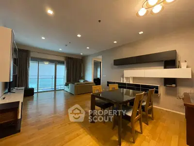 Spacious modern living room with dining area and large windows for natural light.
