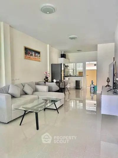 Spacious modern living room with sleek furniture and open layout, perfect for contemporary living.