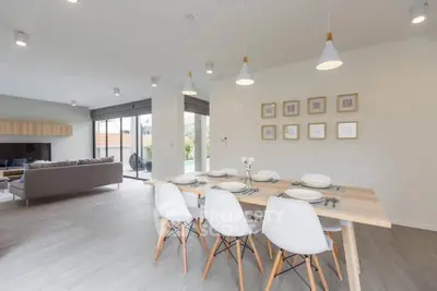 Spacious modern living and dining area with stylish decor and ample natural light.