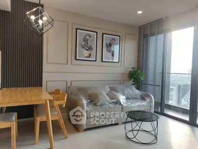 Modern living room with stylish decor and city view balcony.