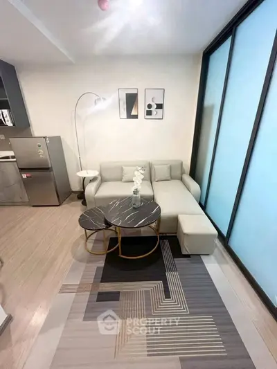 Modern living room with stylish decor and natural light, featuring a cozy sofa and chic coffee tables.