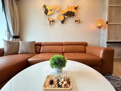 Stylish living room with leather sofa and world map wall art, perfect for modern urban living.