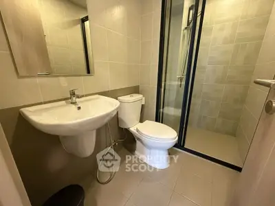 Modern bathroom with sleek fixtures and glass shower enclosure