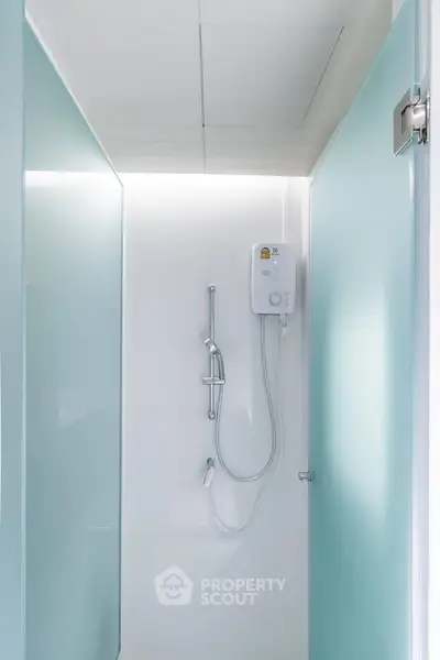 Modern minimalist bathroom with sleek shower design and frosted glass panels.
