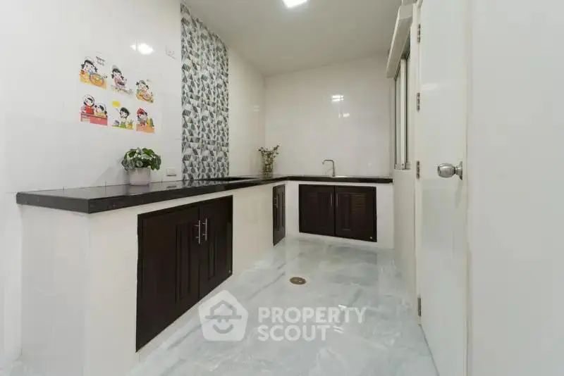 Modern kitchen with sleek countertops and stylish cabinetry in a bright, spacious layout.