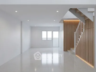 Spacious modern living room with elegant staircase and natural light