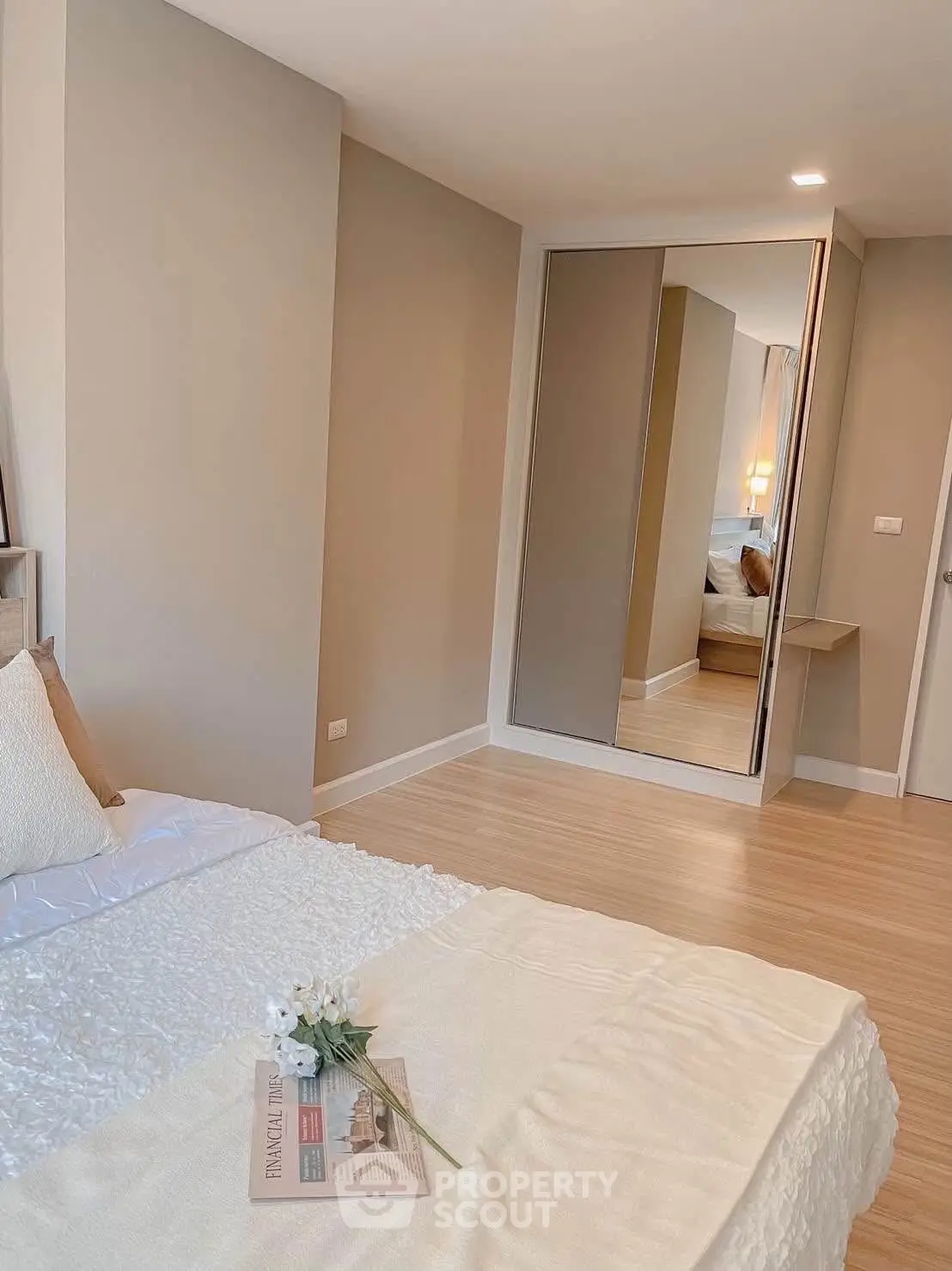 Cozy bedroom with modern decor and mirrored closet doors