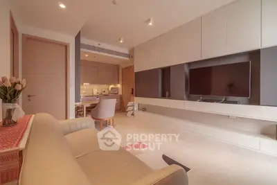 Modern living room with sleek furniture and open kitchen layout, perfect for contemporary living.