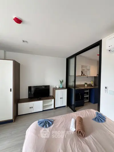 Modern studio apartment with stylish interior and compact kitchen area