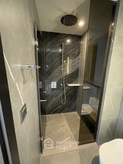 Luxurious modern bathroom with sleek marble tiles and rainfall showerhead
