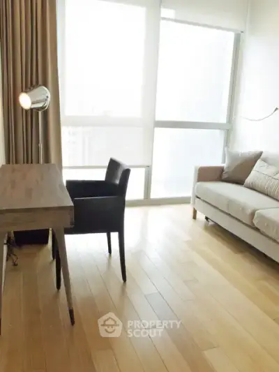 Bright and modern living room with wooden flooring and stylish furniture.