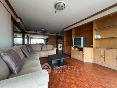 Spacious living room with elegant wooden flooring and built-in entertainment center.