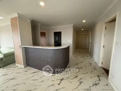 Spacious modern living area with unique marble flooring and stylish bar counter