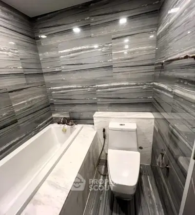 Luxurious marble bathroom with bathtub and modern fixtures