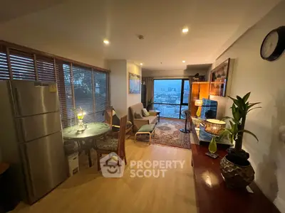 Spacious living room with city view, elegant decor, and natural light.